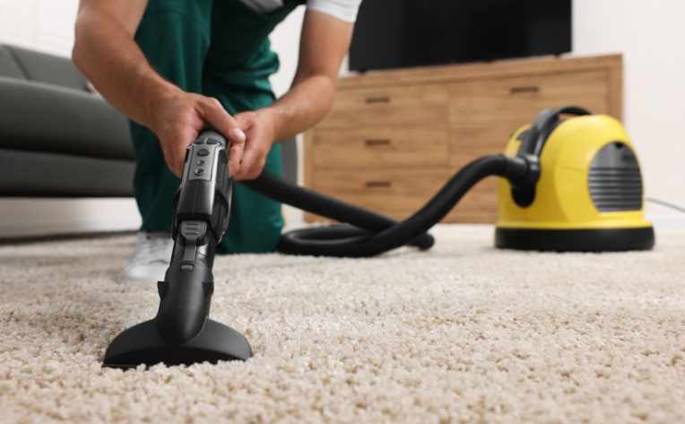 vacuuming a white carpet in living room
